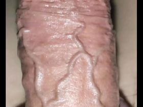 A solo boy tries out a transparent sex toy.