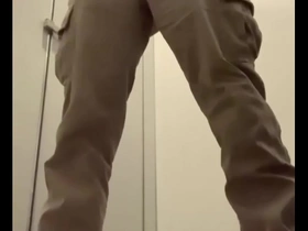 Solo stimulation results in ejaculation while standing at the toilet.