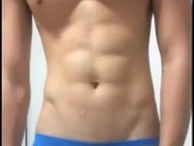 Young Asian man with a six pack masturbates.