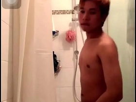 Asian guy shows off his slim body and big cock while showering.