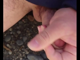 Japanese gay masturbates outdoors on the beach with a great ending.